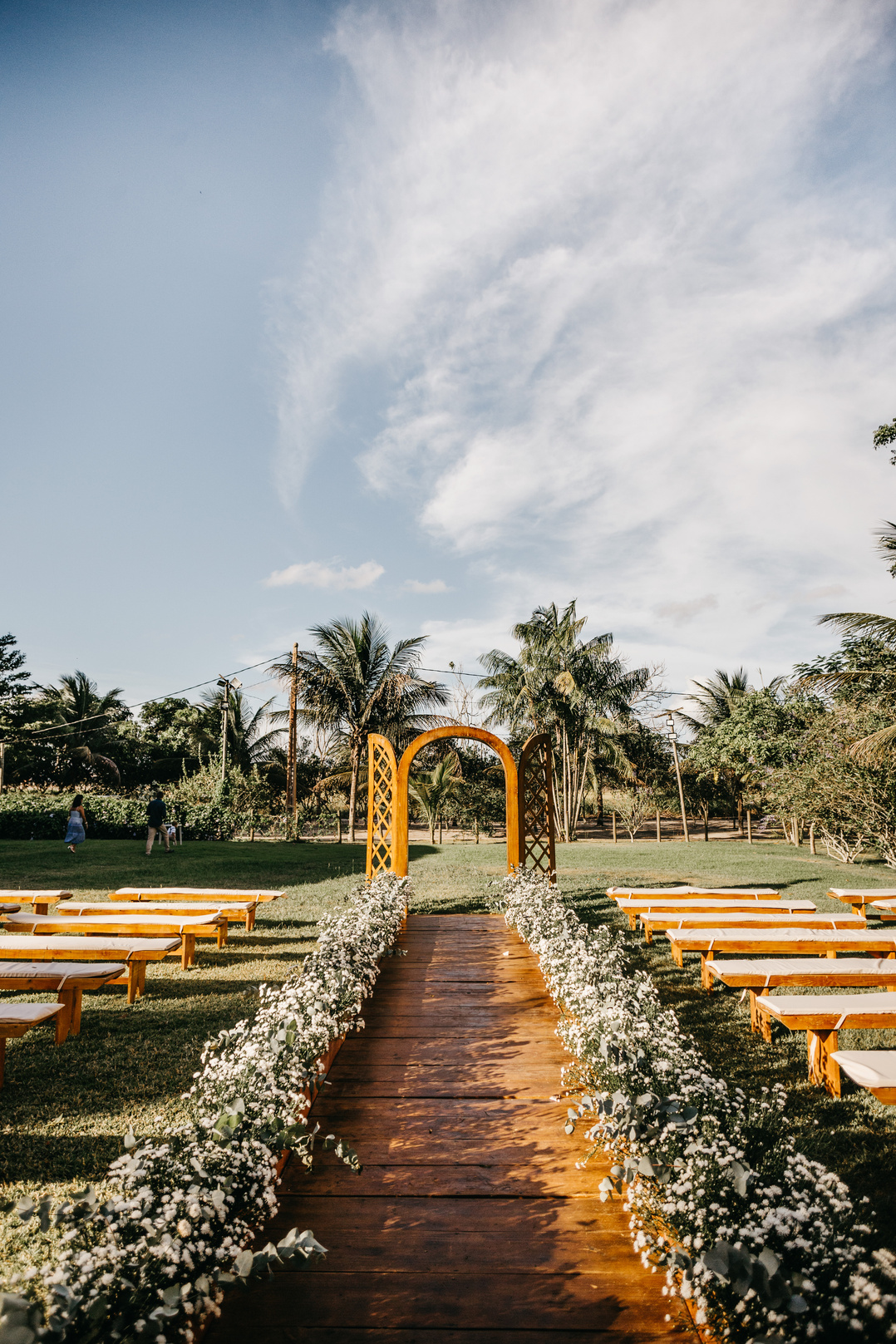 Wedding arch and benches arranged in lush park